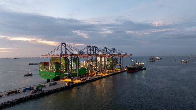 Aerial view of container cargo ship at night, Container cargo ship in global business import export logistic, Logistics and transportation international container cargo ship supply chain.