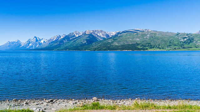 Lake with a rocky near shore and a long distant ridge