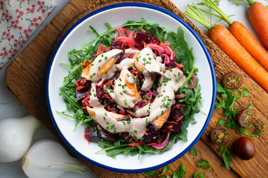 Salmon salad with beetroot, vegetables, and yogurt sauce. Overhead view. 