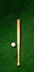 Obraz premium baseball bat and ball on green grass