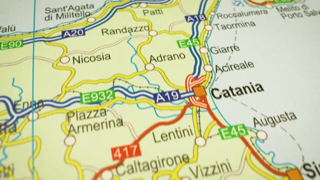 travel route across sicily to messina, italy &ndash; gliding view over atlas map