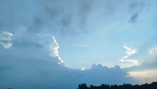 Time lapse of a dramatic cloudscape with white clouds moving across a beautiful blue sky in bright sunlight