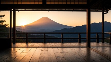 Obraz premium Wooden veranda offers peaceful sunrise view over Mount Fuji with sun rays emerging from behind mountain peak. Gentle mist covers distant hills in early morning calm atmosphere. Traditional Japanese