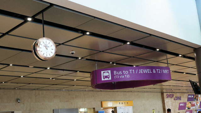 Singapore on 14 April 2026: guide from Terminal 4 to Changi Airport Terminal 1 or Jewel and Terminal 2 or MRT area, a purple signage hanging from the ceiling, showing directional wayfinding for bus