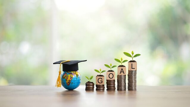 Graduation cap on a globe with growing stacks of coins representing education savings goals for the year 2027