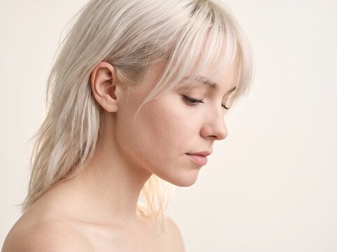 Profile Portrait of Beautiful Young Woman with Platinum Blonde Hair and Bangs