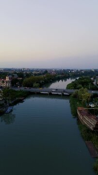 Aerial drone view of the central streets and urban architecture of Poti, Georgia, filmed vertically in 4K on September 15, 2024. The footage shows the city center, streets, buildings, and urban landsc