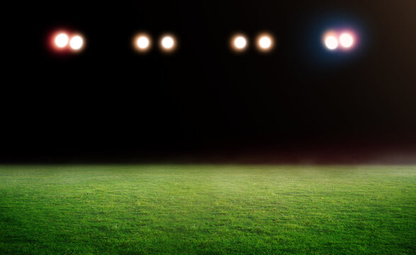 Green soccer field, bright spotlights,	