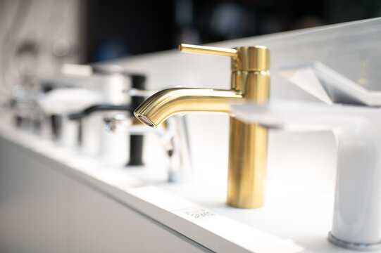 Gold bathroom faucet with modern plumbing fixtures display