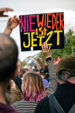 Hamburg, Germany - 12 September 2026: View of a protester holding a sign with the slogan Nie Wieder Ist Jetzt during a demonstration against right-wing politics in Hamburg.