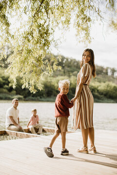 Joyful moments by the lakeside with family on a sunny afternoon