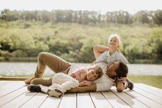 Joyful family moments on the dock surrounded by green nature