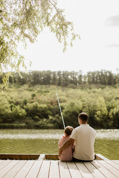 Fishing together on a sunny afternoon by the serene lake