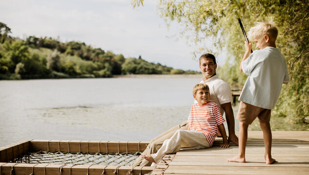 Family enjoying a sunny day by the lake filled with laughter