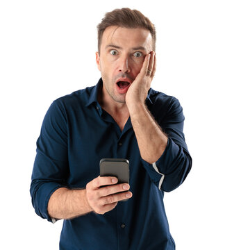 Stunned casual man holding smartphone