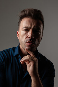 Thoughtful middle aged man touching chin
