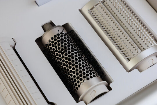 Different types of hair styling tools shown inside a clean box for hair care