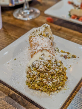 Fresh Italian cannoli dessert with crushed pistachios