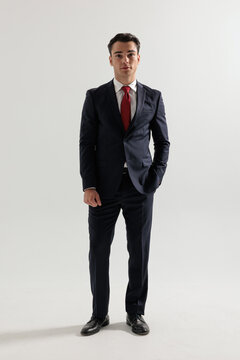Elegant man standing with hand in pocket