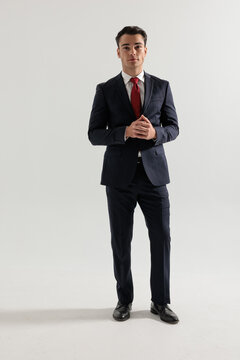 Confident man standing and rubbing hands