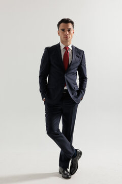 Elegant man standing with hands in pockets
