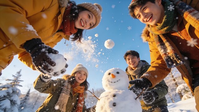 Happy Friends Building Snowman and Throwing Snowballs Low Angle View