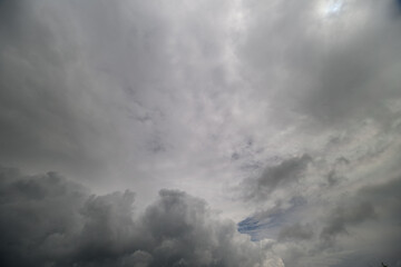 Fototapeta premium Dark, moody clouds swirl above in a dramatic sky, hinting at an incoming storm