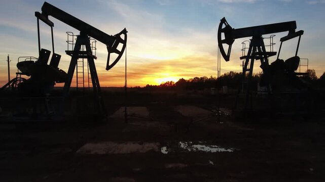 Aerial view of oil pump jacks at sunset in Russia.