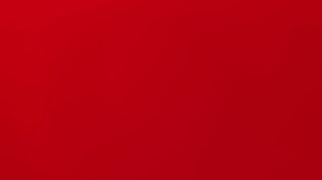 Minimalist motion video footage of a clean, vibrant solid red background surface. Ideal for corporate presentations, broadcast backgrounds, and commercial video overlays.