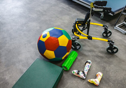 Colorful selection of rehabilitation equipment shows support for kids with cerebral palsy. Walkers, orthoses and various rehabilitation equipment