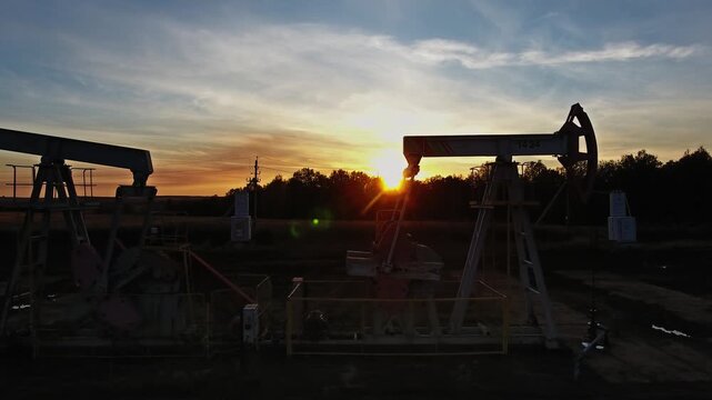 Aerial view of oil pump jacks at sunset in Russia.