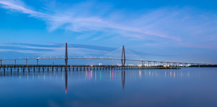 Arthur Ravenel Jr. Bridge and mirror-flat water reflections at dusk across the Cooper River in Charleston South Carolina