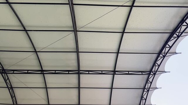 Modern curved metal roof frame structure view from below