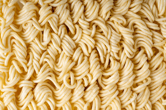 Instant noodles texture background, dry ramen noodle macro pattern