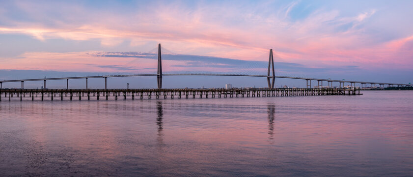 Arthur Ravenel Jr. Bridge and mirror-flat water reflections at dusk across the Cooper River in Charleston South Carolina