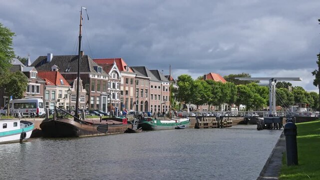 Traditional Dutch wooden sailing ship and iconic white drawbridge along the canal in historic Zwolle, Netherlands on 23 August 2026.