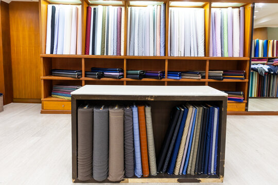 Classic traditional generic bespoke tailoring shop interior with cutting table and bolt of fabric cloths. Perfect to be used as background