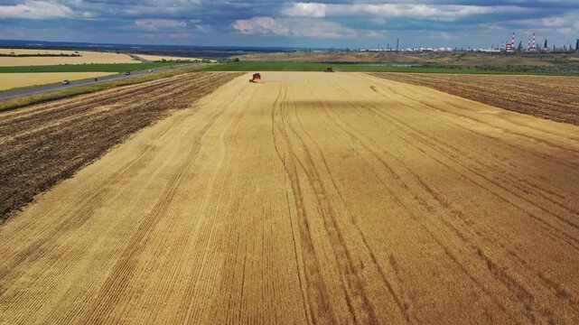 Aerial view of combine harvester in wheat field, RUSSIA.