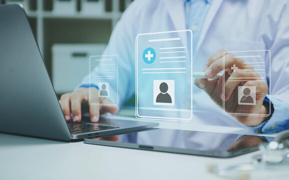 Digital medical records interface with doctor using laptop and stylus enabling secure patient data management electronic healthcare documentation telemedicine and efficient clinical workflow.
