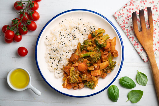 Vegetable and crispy tofu stew served with white rice. Top-down view. Traditional Christmas recipe.