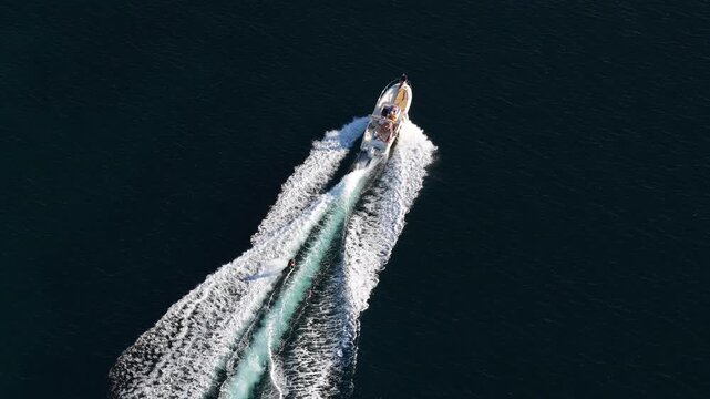 Aerial view of motorboat pulling a wakeboarder in France.