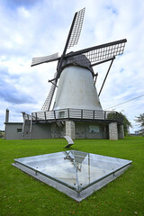 Obraz premium One point of the UNESCO World Heritage Struve Geodetic Arc, Võivere endpoint next to windmill, Estonia. Measured in 1827 this baseline was used as a reference line to calculate the size of the Earth