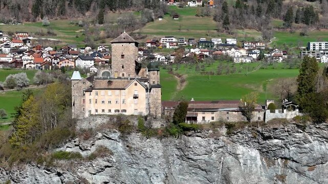 castle tower onion dome ortenstein fortress cliff edge domleschg valley ochre palace tomils village construction crane graubunden switzerland alpine farmland forested heritage site drone footage