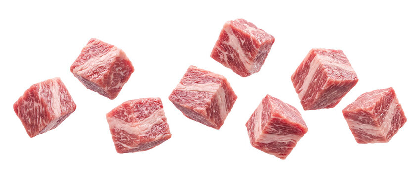 Falling raw beef cubes isolated on transparent background