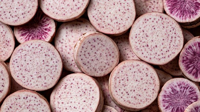 Close-up view of sliced purple taro root with distinctive pinkish-purple speckles