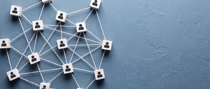 Network of interconnected people represented by wooden blocks