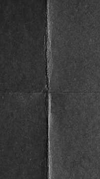 Black paper texture with fold lines, minimalist dark background overlay
