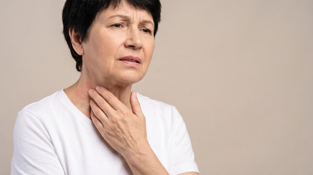 Person touching neck area indicating throat discomfort or swelling related to skin allergy symptoms with potentially linked throat swelling allergic reaction symptoms Swollen area