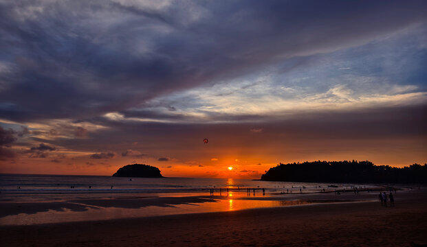 Coastal sunset over rocky shoreline with pink and purple clouds