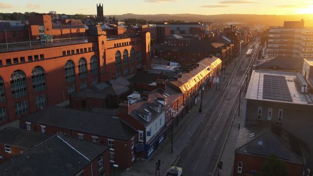 Aerial video of Sunrise Over Union Street and Town Centre and a Tram travelling towards Rochdale. 